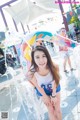 A young woman standing in front of a water fountain.