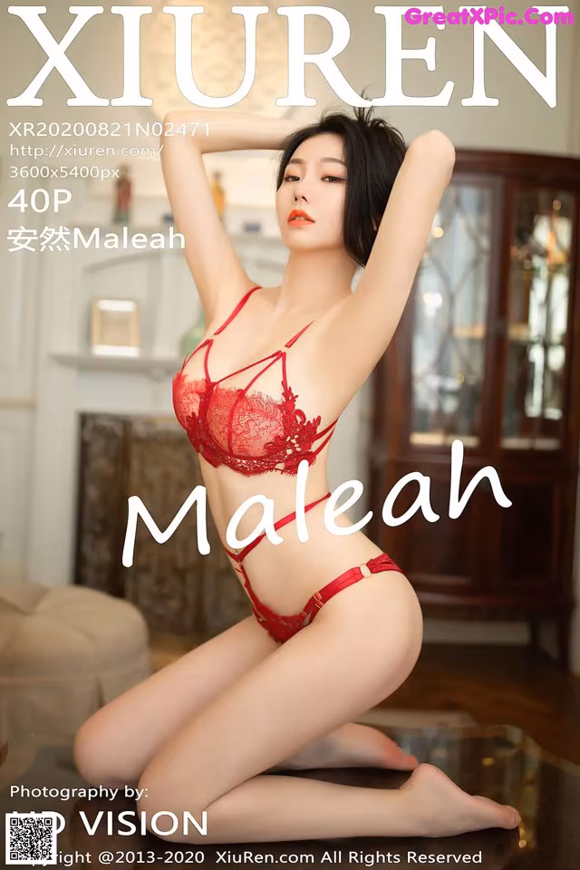A woman in a red lingerie sitting on a table.